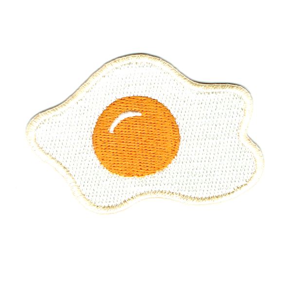 Fried egg iron on patch with yellow yolk in the middle