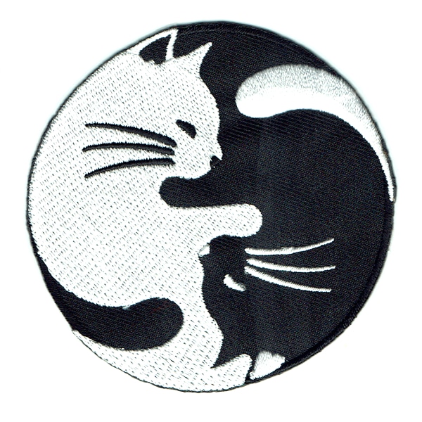 Round iron on embroidered patch of a black and white cat in yin yang pose