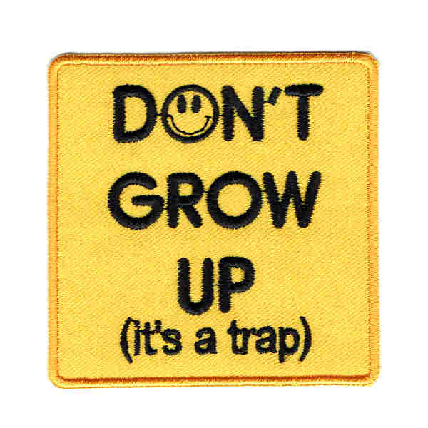 Square yellow iron on patch with the words don't grow up its a trap embroidered in black