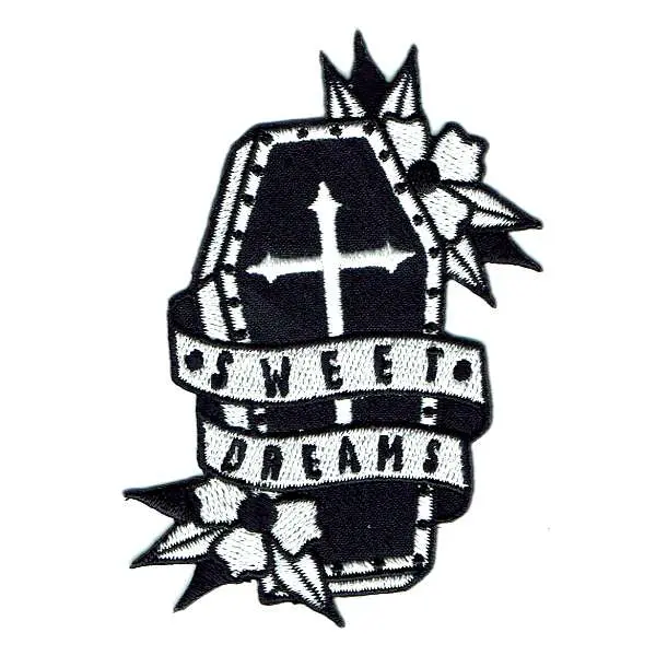 Black coffin iron on patch with the words sweet dreams embroidered around it.